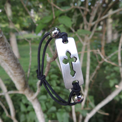 MB354  2" Stretch-fit cord bracelet Displays a pewter charm with cross cut-out design.