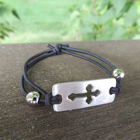 MB354  2" Stretch-fit cord bracelet Displays a pewter charm with cross cut-out design.
